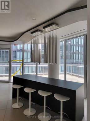 Toronto (Church-Yonge Corridor) condo for rent - A black bar with three white stools in front of a window.