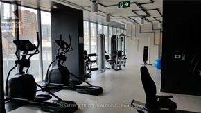 Toronto (Church-Yonge Corridor) condo for rent - A gym with exercise equipment and a green exit sign.