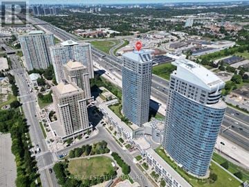 Toronto (Woburn) condo for rent - A bird's eye view of a city with tall buildings and a highway.