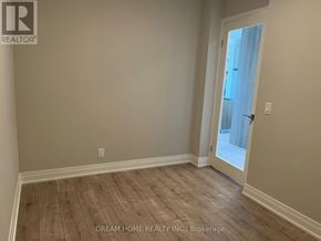 Markham (Unionville) condo for rent - A room with wooden flooring and a door leading outside.