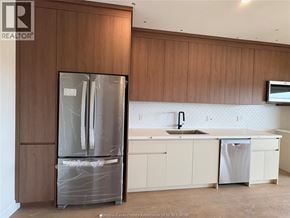 Lasalle townhouse for rent - A kitchen with a refrigerator, sink, and cabinets.