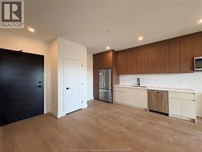 Lasalle townhouse for rent - A kitchen with wooden cabinets and a refrigerator.