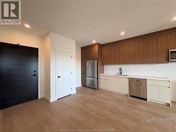 Lasalle townhouse for rent - A kitchen with wooden cabinets and a refrigerator.