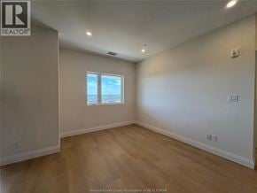 Lasalle townhouse for rent - A room with a window and wooden flooring.