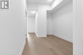 Toronto (Yonge-Eglinton) condo for rent - A room with white walls and wooden flooring, with a logo in the top left corner that reads "REALTOR".