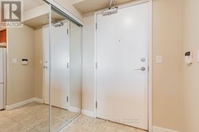 Toronto (Woburn) condo for rent - A brokerage sign is on the wall of a room with three white doors.