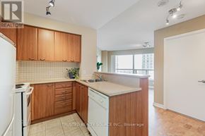 Toronto (Woburn) condo for rent - A kitchen with wooden cabinets and a white refrigerator.
