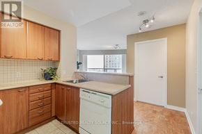 Toronto (Woburn) condo for rent - A kitchen with wooden cabinets and a washing machine.