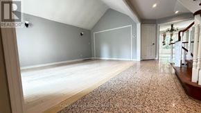 Markham (Unionville) apartment for rent - A spacious room with a carpeted floor and a staircase on the right side.