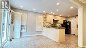 Markham (Unionville) apartment for rent - A kitchen with a black refrigerator and wooden cabinets.