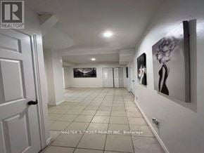 Toronto (Hillcrest Village) apartment for rent - A hallway with a white door and pictures on the wall.