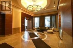 Toronto (Bay Street Corridor) condo for rent - A large, well-lit foyer with a circular light fixture and a black and white rug.