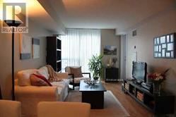 Toronto (Bay Street Corridor) condo for rent - A living room with a couch, chairs, and a television.