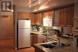 Toronto (Bay Street Corridor) condo for rent - A kitchen with a refrigerator and a sink.
