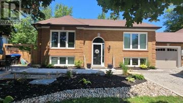 Wasaga Beach apartment for rent - A house with a red brick exterior and a black front door.