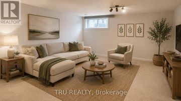 Ottawa townhouse for rent - A living room with a couch, chair, and a painting on the wall.