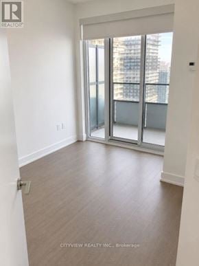 Toronto (Mimico) condo for rent - A room with a sliding glass door leading to a balcony.