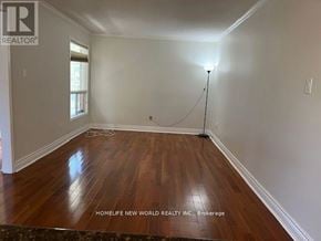 Markham (Milliken Mills East) apartment for rent - A room with wooden flooring and a light on a stand.