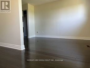 Markham (Milliken Mills East) apartment for rent - A room with a wooden floor and a door on the left side.