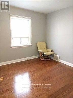 Toronto (Willowdale East) apartment for rent - A room with a wooden floor and a chair.