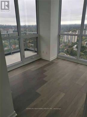 Toronto (Henry Farm) condo for rent - A room with a view of the city through large windows.