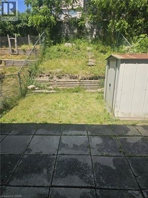 Woodstock townhouse for rent - A backyard with a shed and a fence.