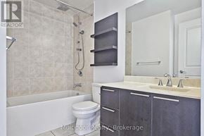Toronto (Mimico) condo for rent - A bathroom with a white tub, sink, and toilet.
