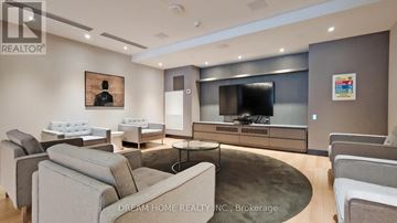 Toronto (Mount Pleasant West) condo for rent - A modern living room with a grey couch and a television.