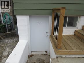 Hamilton apartment for rent - A white door is on the left of a wooden porch.