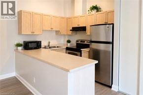 Burlington townhouse for rent - A kitchen with wooden cabinets and stainless steel appliances.