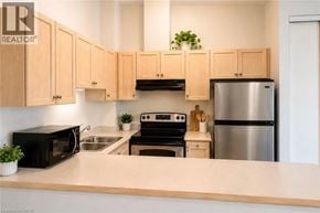 Burlington townhouse for rent - A kitchen with wooden cabinets and a stainless steel refrigerator.