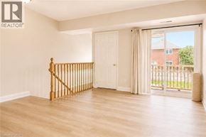 Burlington townhouse for rent - A room with a wooden staircase and sliding glass doors.