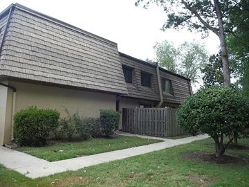 Newport News apartment for rent - A house with a brown roof and a white fence.
