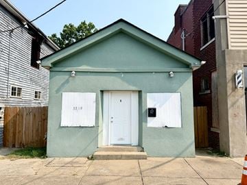 Louisville apartment for rent - A small green house with a white door and windows.