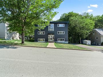 Dartmouth apartment for rent - A modern two-story house with a flat roof and large windows.