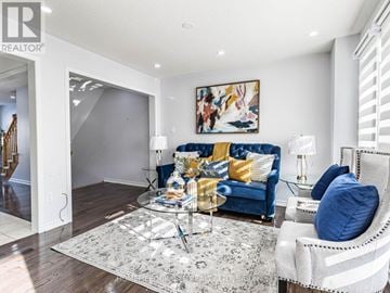 Brampton (Northwest Brampton) townhouse for rent - A living room with a blue couch and a glass table.