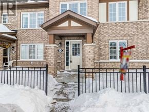 Brampton (Northwest Brampton) townhouse for rent - A house with a black fence and a white door.