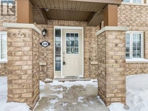 Brampton (Northwest Brampton) townhouse for rent - A house numbered 229 is shown with a white door and a brown brick pillar.