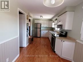 Toronto (L'amoreaux) apartment for rent - A kitchen with white cabinets and a wooden floor.