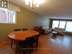 Toronto (L'amoreaux) apartment for rent - A dining room with a wooden table and chairs.