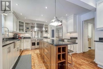 Markham (Unionville) apartment for rent - A modern kitchen with white cabinets and a central island.