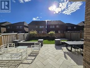 Bradford West Gwillimbury (Bradford) apartment for rent - A sunny day in a backyard with a table and chairs.