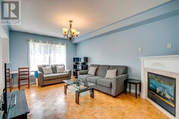 Newmarket (Summerhill Estates) apartment for rent - A living room with a fireplace and a painting on the wall.