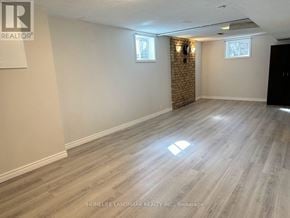 Toronto (Malvern) apartment for rent - A room with wooden flooring and a brick wall.
