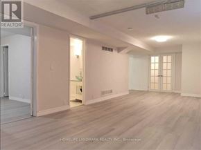 Toronto (Malvern) apartment for rent - A spacious room with light wood flooring and white walls.