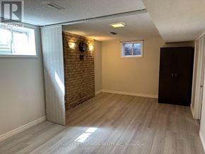 Toronto (Malvern) apartment for rent - A room with a brick wall and wooden flooring.