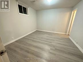 Toronto (Malvern) apartment for rent - A room with a window and wooden flooring.