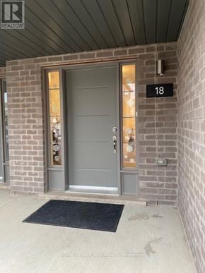 Kitchener townhouse for rent - A grey door with a black mat in front of it.
