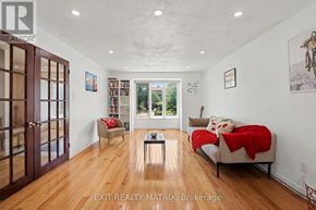 Ottawa apartment for rent - A bedroom with a bed, a chair, and a bookshelf.