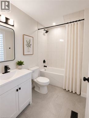 Hamilton apartment for rent - A white bathroom with a toilet, sink, and bathtub.